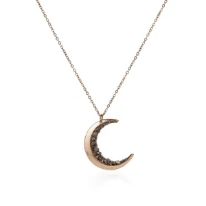 Irregular crescent moon necklace with diamonds and a snake bone chain.